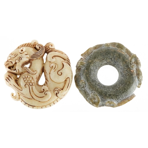 1191 - Two Chinese carved stone dragon discs, the largest 5cm in diameter.