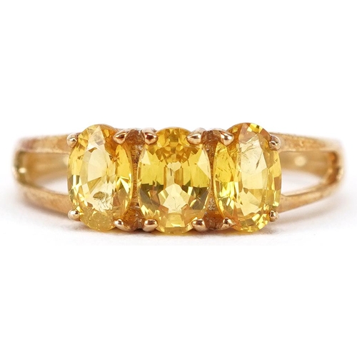 2208 - A 9ct gold yellow topaz three stone ring, size N, 2.4g.