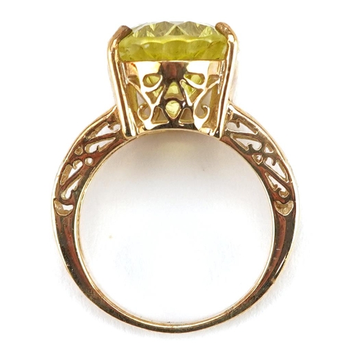 2395 - A large 9ct gold citrine solitaire ring with pierced shoulders, size N, 7.3g.