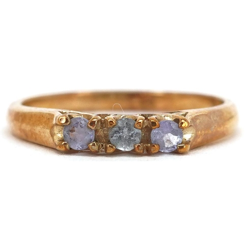 2212 - A 9ct gold blue and purple stone three stone ring, size N, 1.9g.