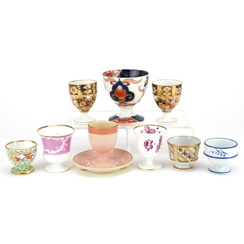 253 - A group of nine various 19th century and later porcelain eggcups, the largest 8cm high.