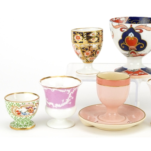 253 - A group of nine various 19th century and later porcelain eggcups, the largest 8cm high.