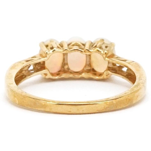 2351 - A 9ct gold cabochon opal three stone ring, size N, 2.1g.