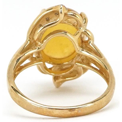 2362 - A 9ct gold cabochon orange stone and diamond dress ring, size N, 4.5g.