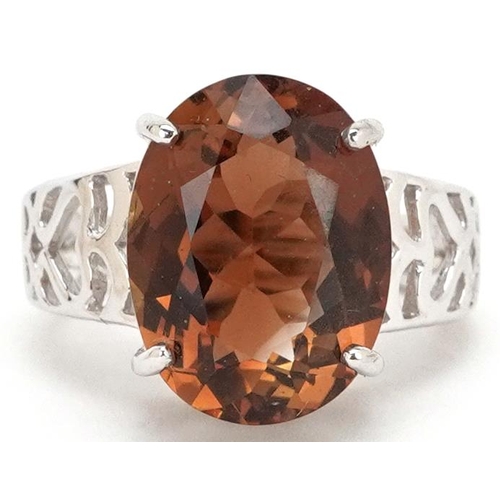 2493 - A large 9ct white gold orange stone ring, tests as sapphire, the stone approximately 15.60mm x 12.0m... 