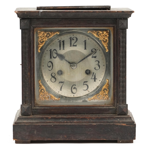 1252 - An early 20th century oak cased mantle clock, the silvered dial raised on a plinth base, with pendul... 