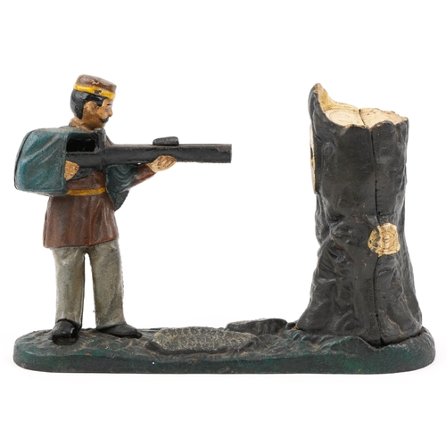 535 - An early 20th century Book of Knowledge cast iron and hand painted coin bank modelled as a man shoot... 