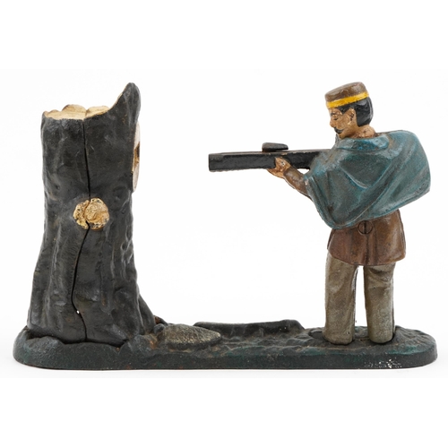 535 - An early 20th century Book of Knowledge cast iron and hand painted coin bank modelled as a man shoot... 