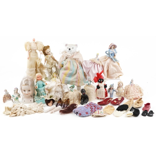 1287 - A small collection of early 20th century porcelain, bisque and plastic half dolls and full length do... 