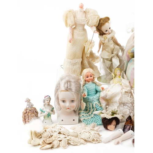 1287 - A small collection of early 20th century porcelain, bisque and plastic half dolls and full length do... 