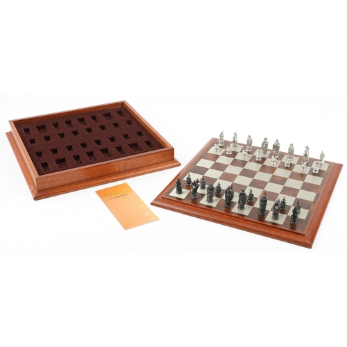 587 - A Camelot chess set by Selangor Pewter within a rosewood box, 39cm wide.