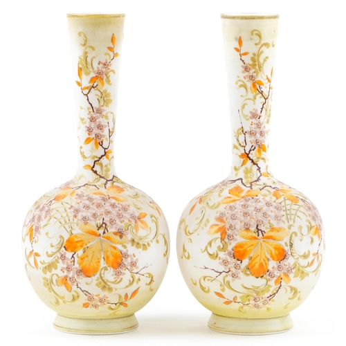 252 - A pair of early 20th century French opaline glass bottleneck vases, each with hand painted floral de... 