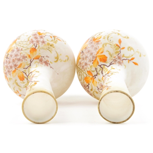 252 - A pair of early 20th century French opaline glass bottleneck vases, each with hand painted floral de... 