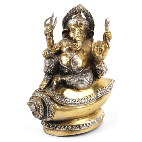 148 - An Indian gilt metal figure of Ganesha, 20th century, modelled seated upon shell, 15cm high.