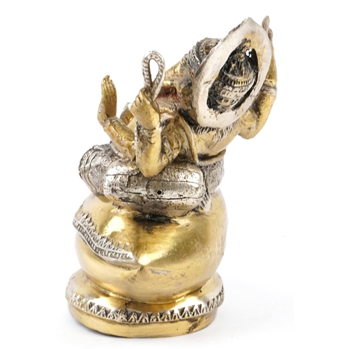 148 - An Indian gilt metal figure of Ganesha, 20th century, modelled seated upon shell, 15cm high.