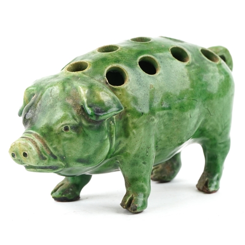 260 - An early 20th century green glazed terracotta model of a pig, 18cm in length.