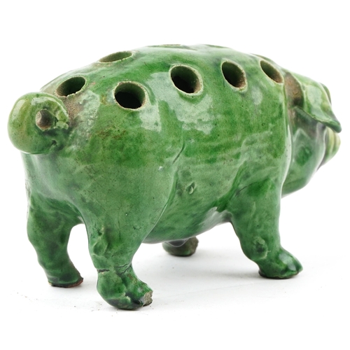 260 - An early 20th century green glazed terracotta model of a pig, 18cm in length.