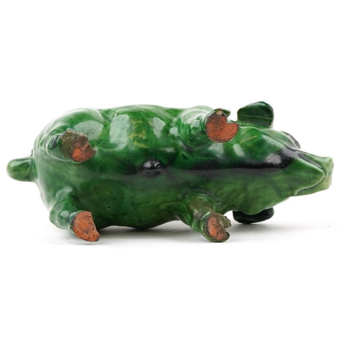 260 - An early 20th century green glazed terracotta model of a pig, 18cm in length.