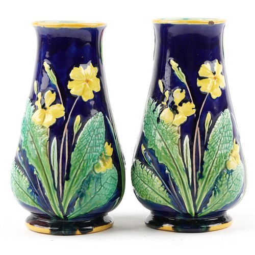 1288 - A pair of early 20th century Majolica pottery vases, each with floral decoration, bearing impressed ... 