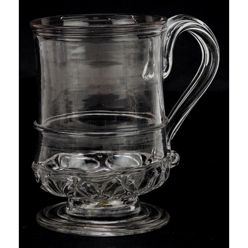 138 - A 19th century hand blown clear glass tankard, 10cm high.