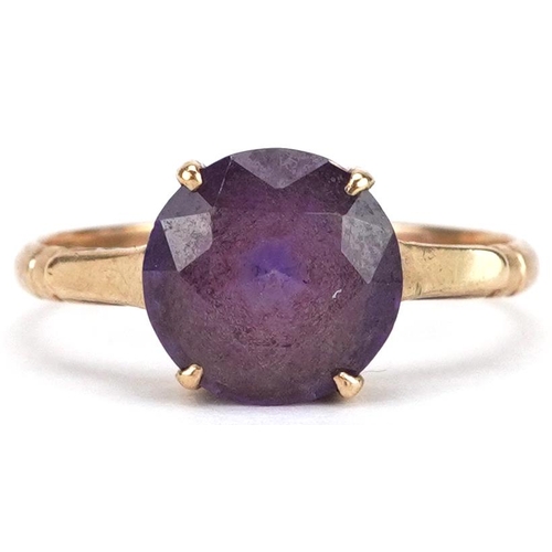 2211 - A 9ct gold blue/purple stone solitaire ring, possibly alexandrite, size N/O, 2.3g.