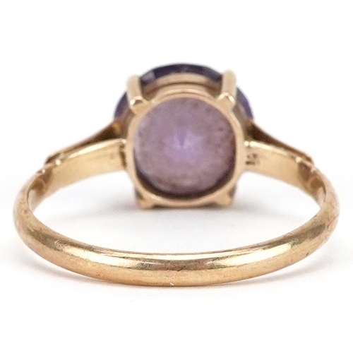 2211 - A 9ct gold blue/purple stone solitaire ring, possibly alexandrite, size N/O, 2.3g.