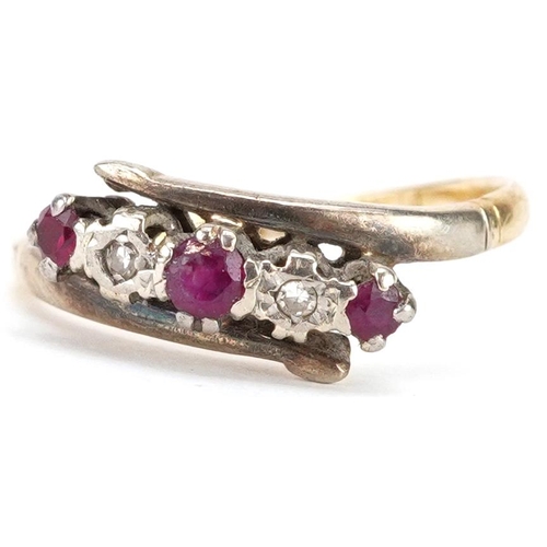 2194 - An 18ct gold and platinum ruby and diamond crossover ring, size J, 2.3g.