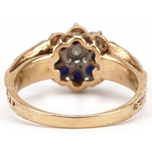 2061 - A 9ct gold diamond and blue spinel flower head ring with naturalistic setting, size N, 3.4g.