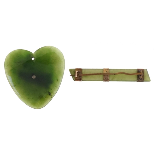 2511 - A green jade brooch with 9ct mounts and a New Zealand jade love heart pendant with yellow metal moun... 