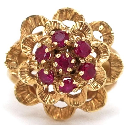 A continental gold ruby flower head ring, size M, 5.7g.