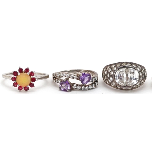 2518 - Seven silver rings set with semi precious stones including emerald, ruby and amethyst, various sizes... 