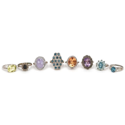 2526 - Eight silver rings set with semi precious stones including citrine, sapphire and amethyst, various s... 