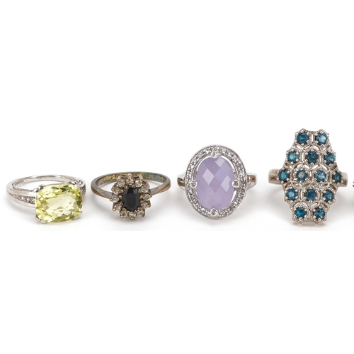 2526 - Eight silver rings set with semi precious stones including citrine, sapphire and amethyst, various s... 