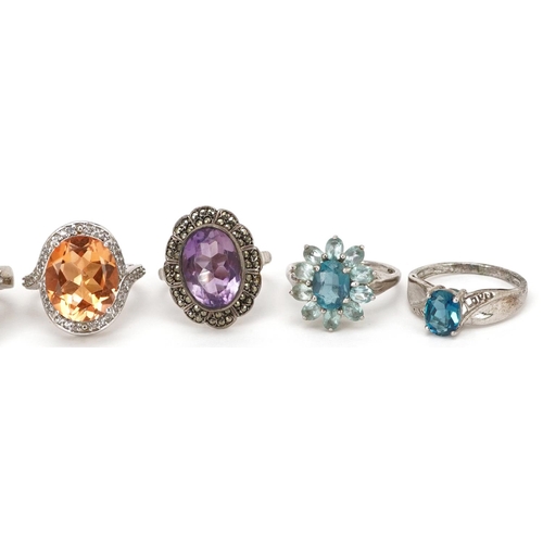 2526 - Eight silver rings set with semi precious stones including citrine, sapphire and amethyst, various s... 