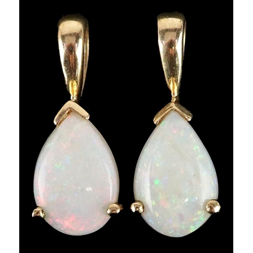 2531 - A pair of unmarked gold opal teardrop pendants, 1.6cm high, total 1.6g.