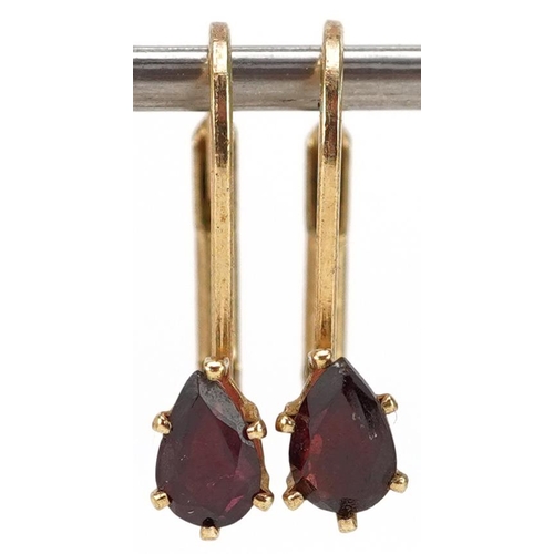 2392 - A pair of yellow metal garnet teardrop earrings, 1.7cm high, total 1.3g.