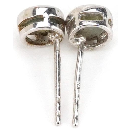 2361 - A pair of 9ct white gold blue stone stud earrings, 5.8mm in diameter, total 0.9g.