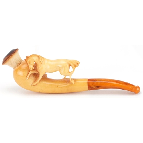 288 - An antique Meerschaum pipe with amber coloured mouthpiece in the form of a horse, housed in a silk l... 