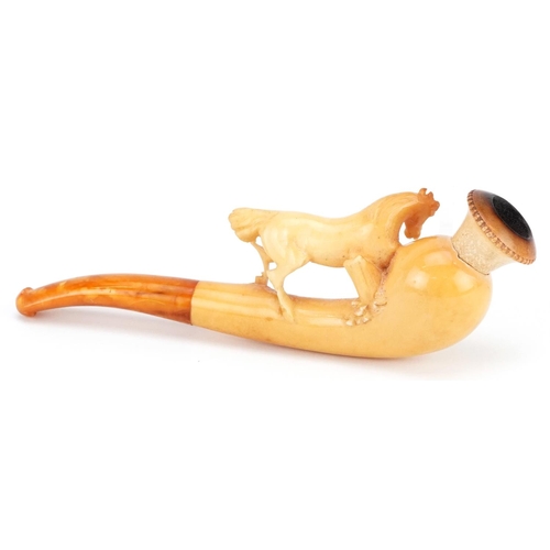 288 - An antique Meerschaum pipe with amber coloured mouthpiece in the form of a horse, housed in a silk l... 