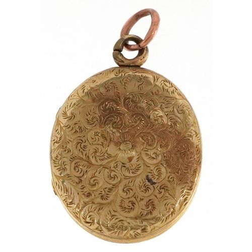 2342 - A Victorian yellow metal locket engraved with foliage, 2.6cm high, 5.2g.