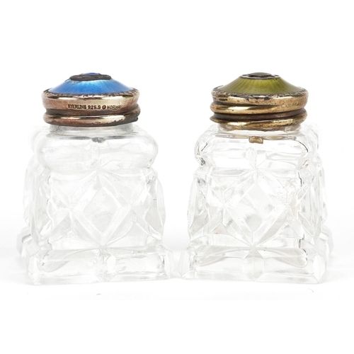 239 - A pair of Norwegian silver gilt and guilloche enamel mounted cut glass casters, 4.2cm high.