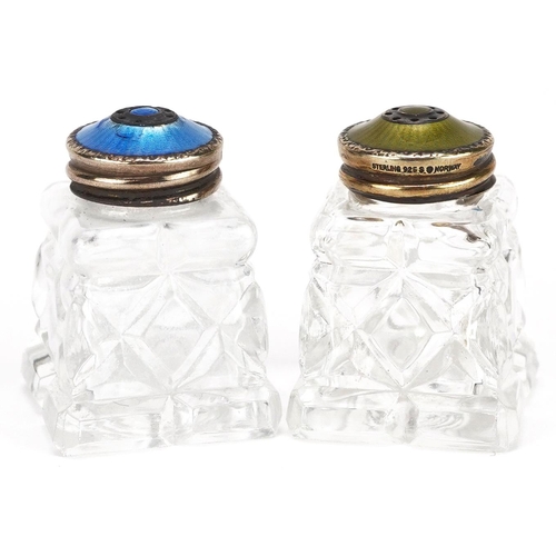 239 - A pair of Norwegian silver gilt and guilloche enamel mounted cut glass casters, 4.2cm high.