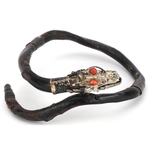 62 - Antique Chinese silver mounted gnarled wood bangle in the form of a dragon with coral eyes, 7.5cm in... 