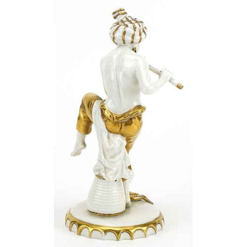 405 - Sitzendorf, German partially gilt porcelain figure of a snake charmer, 21.5cm high