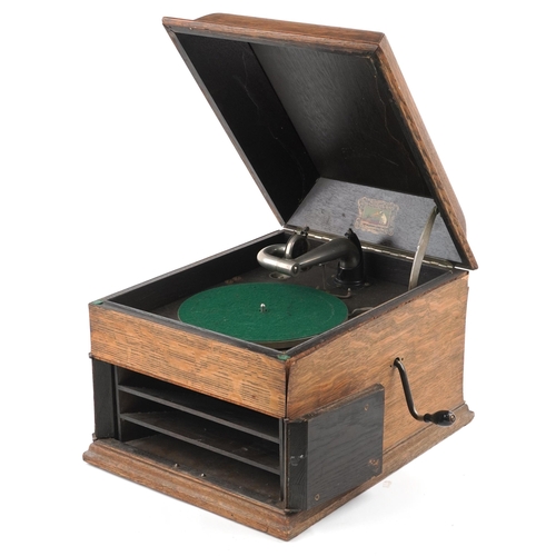 1060 - An early 20th century HMV table top gramophone within an oak case, 38cm wide.