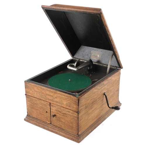 1060 - An early 20th century HMV table top gramophone within an oak case, 38cm wide.