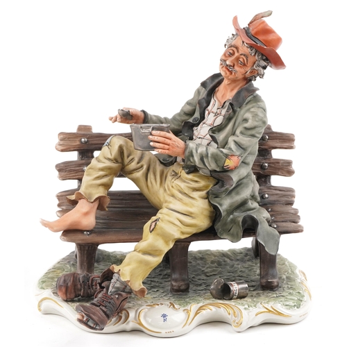 450 - A large 20th century Capodimonte porcelain tramp on a bench group, bearing signature, 33cm H x 33cm ... 