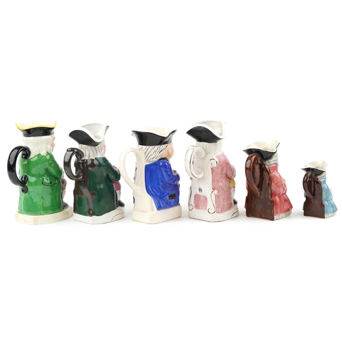 457 - A group of six 20th century Toby jugs with hand painted decoration, variously sized.