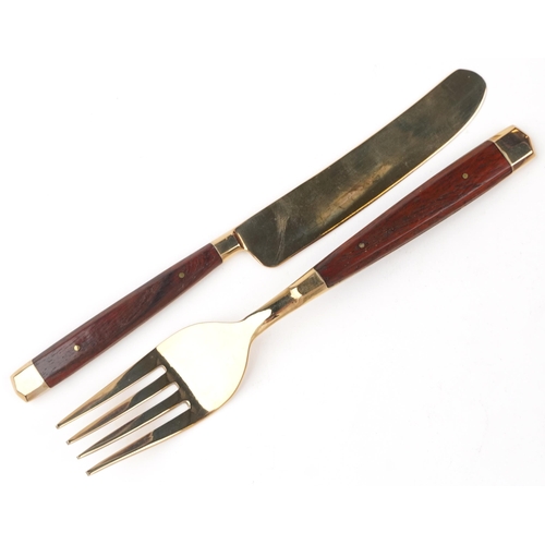 591 - A six place mahogany canteen of bronze cutlery with wooden handles, the canteen 42.5cm wide.