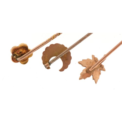 3407 - Three antique and later 9ct gold and yellow metal stickpins including a maple leaf and one set with ... 